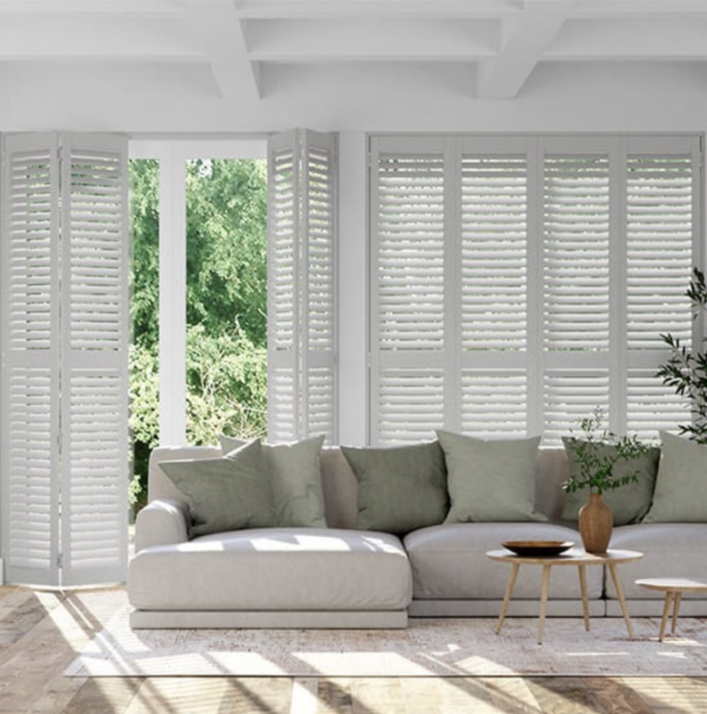 “Full height plantation shutters over patio doors in a modern home, custom fitted by Solacraft Blinds in Southampton